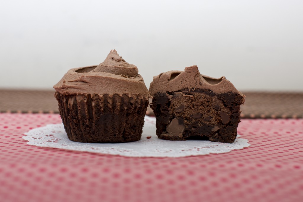 Brownie cupcake with chocolate chocolate chip cookie inside topped with chocolate buttercream