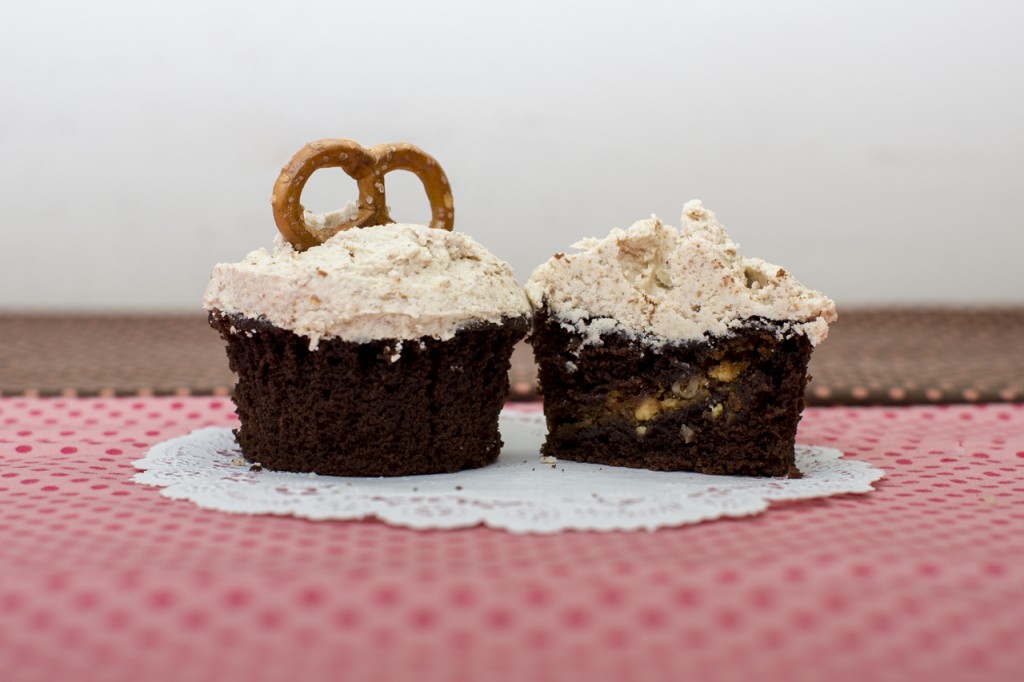 Devil’s food cupcake with white chocolate pecan cookie inside topped with pretzel buttercream