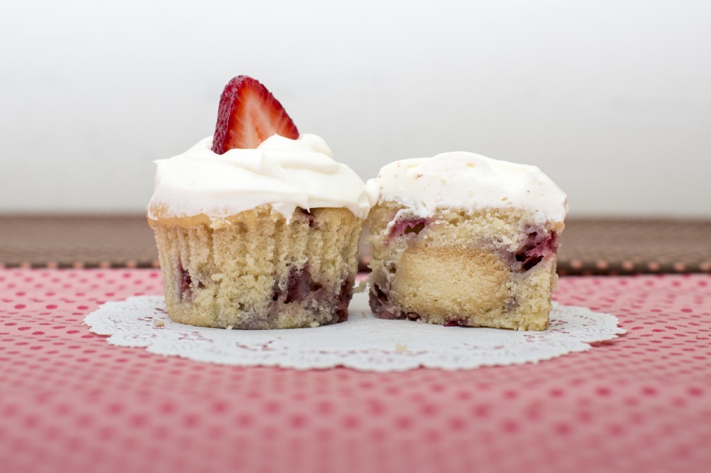 Strawberry cupcake with shortbread inside topped with whipped cream frosting