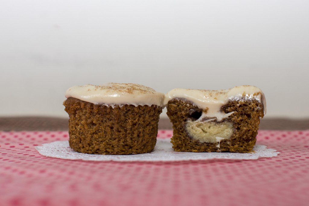 Pumpkin cupcake with snickerdoodle cookie inside topped with maple cream cheese frosting